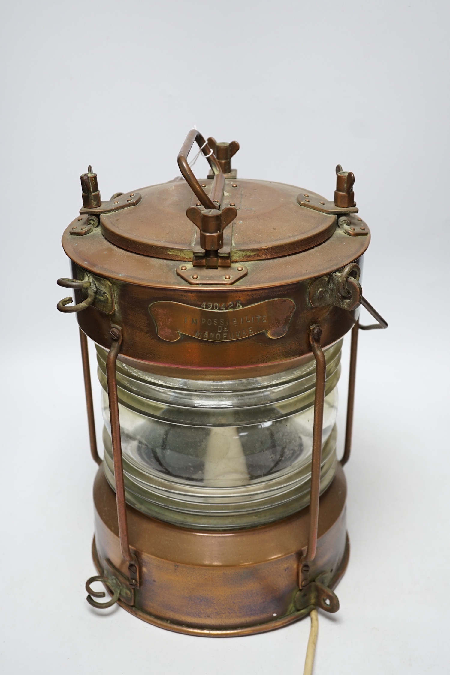 A copper ship’s lamp, with fresnel lens glass, 40cm high